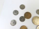 a lot of coins that are on a white surface