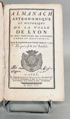 an open book with a picture of a crown on it