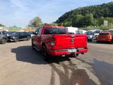 a red truck that is parked in a parking lot