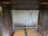 a door in the back of a truck that is being used as a bed