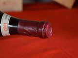 a bottle of wine on a table with a red cloth