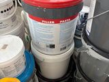 many buckets of paint sitting on the floor next to each other