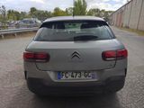 a silver car that is parked on the side of the road