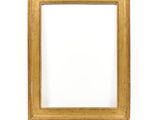 an old gold picture frame on a white wall with a white background