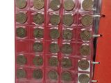 a red book with a bunch of coins inside of it