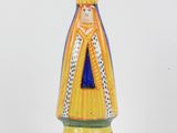 a ceramic figurine of a woman with a crown on her head