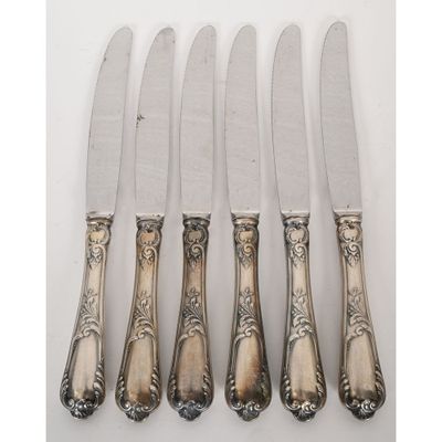 a set of five silverplated knives with ornate handles
