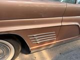 a brown car that is parked on the side of the street