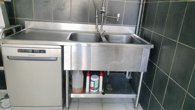 a stainless steel sink and dishwasher in a small kitchen