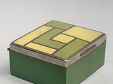 a small green box with a yellow and green design on it