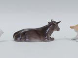 three figurines of animals that are sitting next to each other