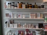 many bottles of hair products on the shelves in the room