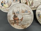 several plates with different designs on them sitting on a table