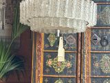 a chandelier hanging from the ceiling in a living room