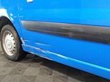 a blue van that is parked in a garage