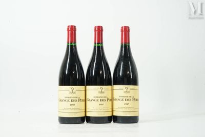 three bottles of wine sitting on top of a white table