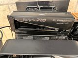 a box of babylis pro hair straightens sitting on top of a table