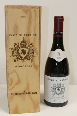 a bottle of wine sitting next to a wooden box