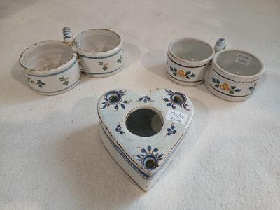 a heart shaped box with a spoon and cups on a table