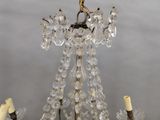 a chandelier with a bird on top of it
