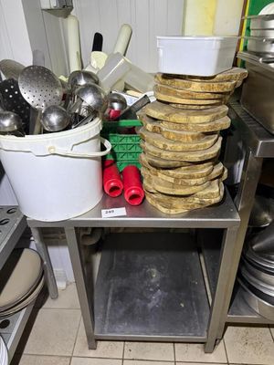 many pots and pans stacked on a table in the kitchen