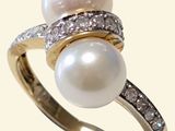 an image of a pearl and diamond ring on a white background