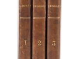 three old books are stacked on top of each other on a white surface
