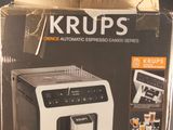 packaging of a coffee machine sitting on a table in front of a window