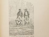 un vieux livre sur lequel figure le dessin de deux hommes et d'un chien