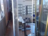 a room with a lot of glass shelves and a vacuum in it