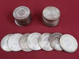 some silver coins are sitting on a red cloth