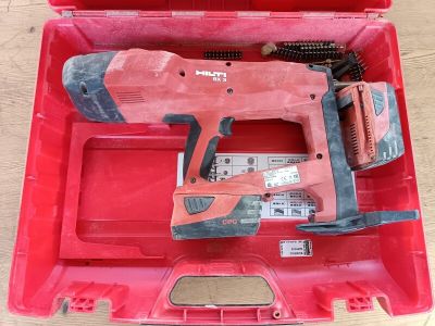 une boîte à outils rouge contenant une perceuse et d'autres outils