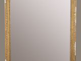 a gold framed mirror on a wall with a wooden frame