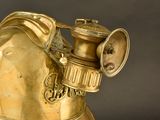 a gold statue of a fire hydrant on a black background