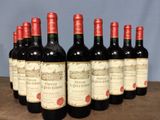 six bottles of red wine are lined up on a wooden table