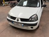 a white car parked in a garage with other cars in the background