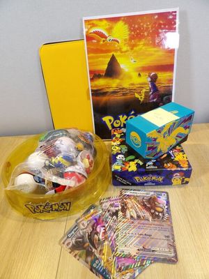 a box of pokemon cards, a box of cards, and a box of cards on a table