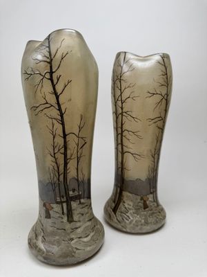 two vases that have been painted with trees on them