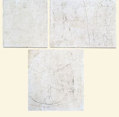 three pieces of paper with drawings on them sitting on a table