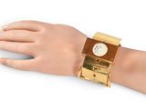 bracelet with a clock on it on a hand on a white background