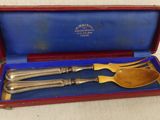 two spoons and a fork in a case