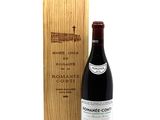 a bottle of wine sitting next to a wooden box