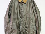 an image of a jacket hanging on a hanger on a wall