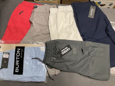 several pairs of men ' s shorts sitting on top of a table