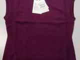 a close up of a purple sweater with a tag on it