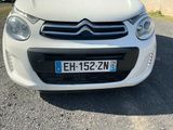 a small white car parked in a parking lot