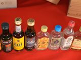 many bottles of alcohol lined up on a red table