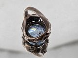 a silver ring with a blue stone inside of it