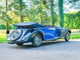 a blue vintage car parked on the side of the road
