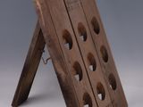 an old wooden wine rack with six bottles of wine on it